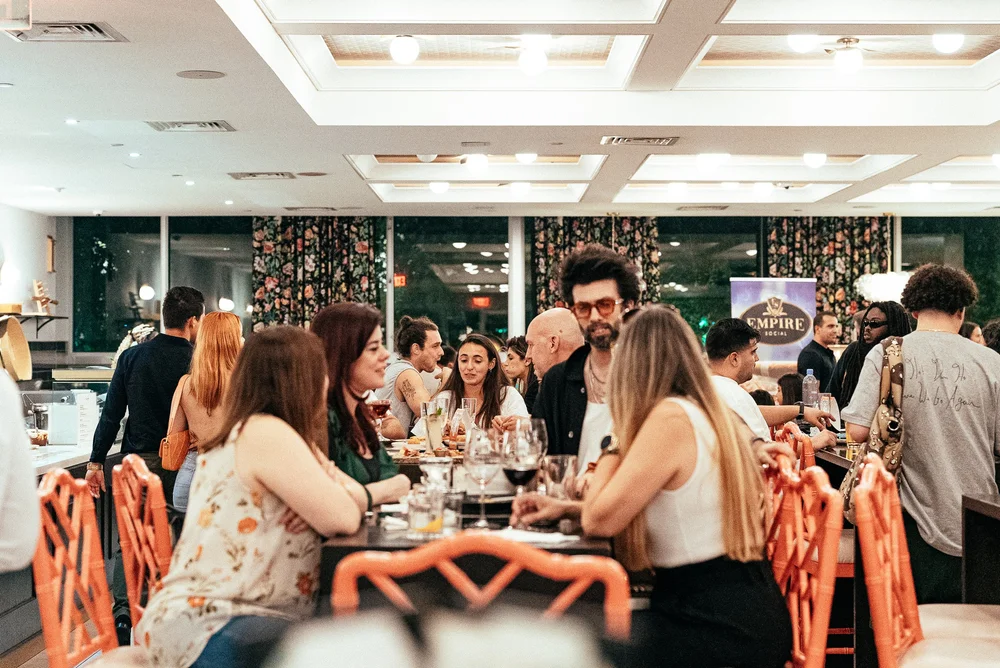 Guests dining and socializing together at Mia Market food court in Miami Guests dining and socializing together at Mia Market food court in Miami